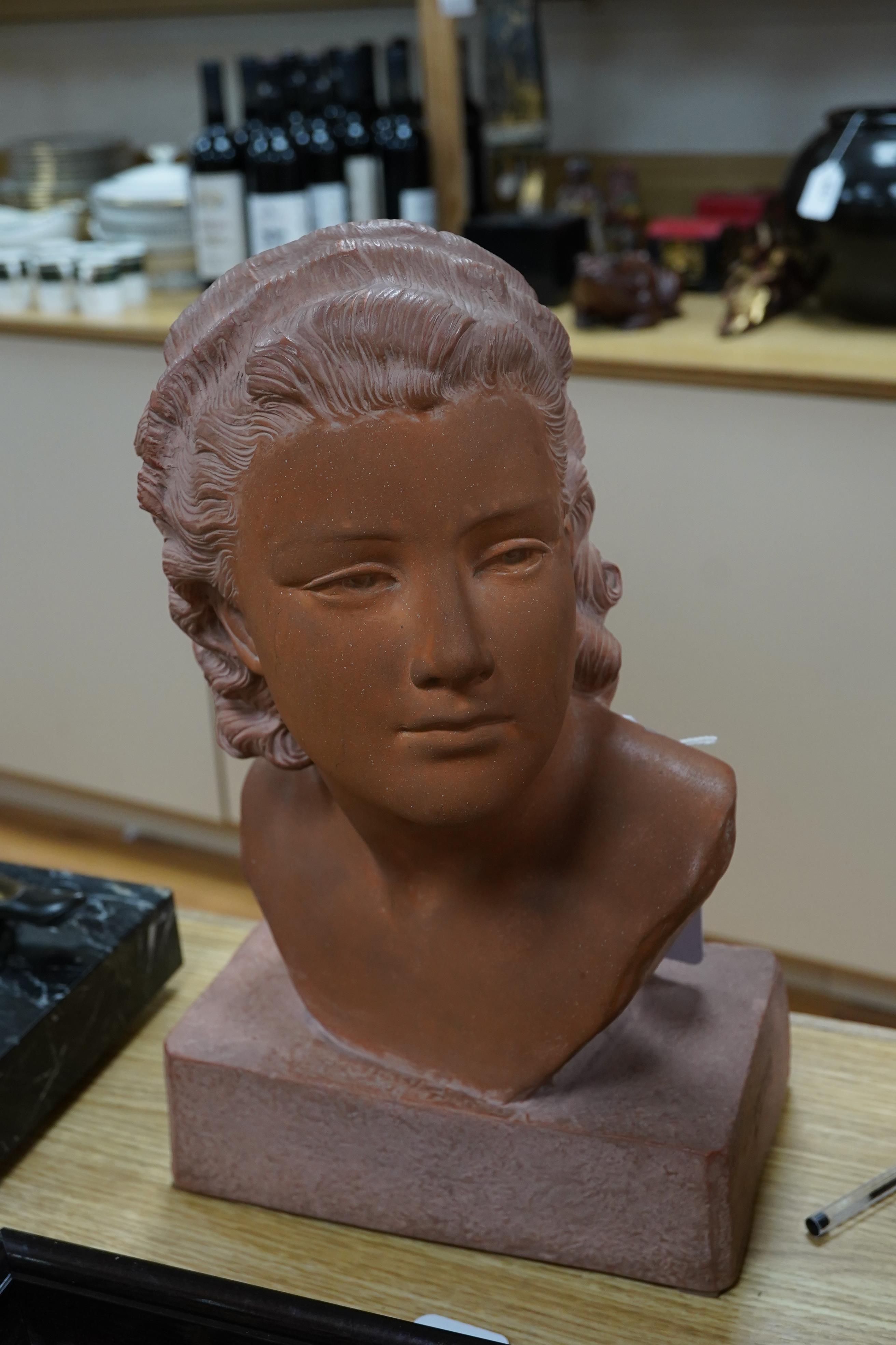 A terracotta bust of a young woman, signed U Cipriani, 37cm high. Condition - good